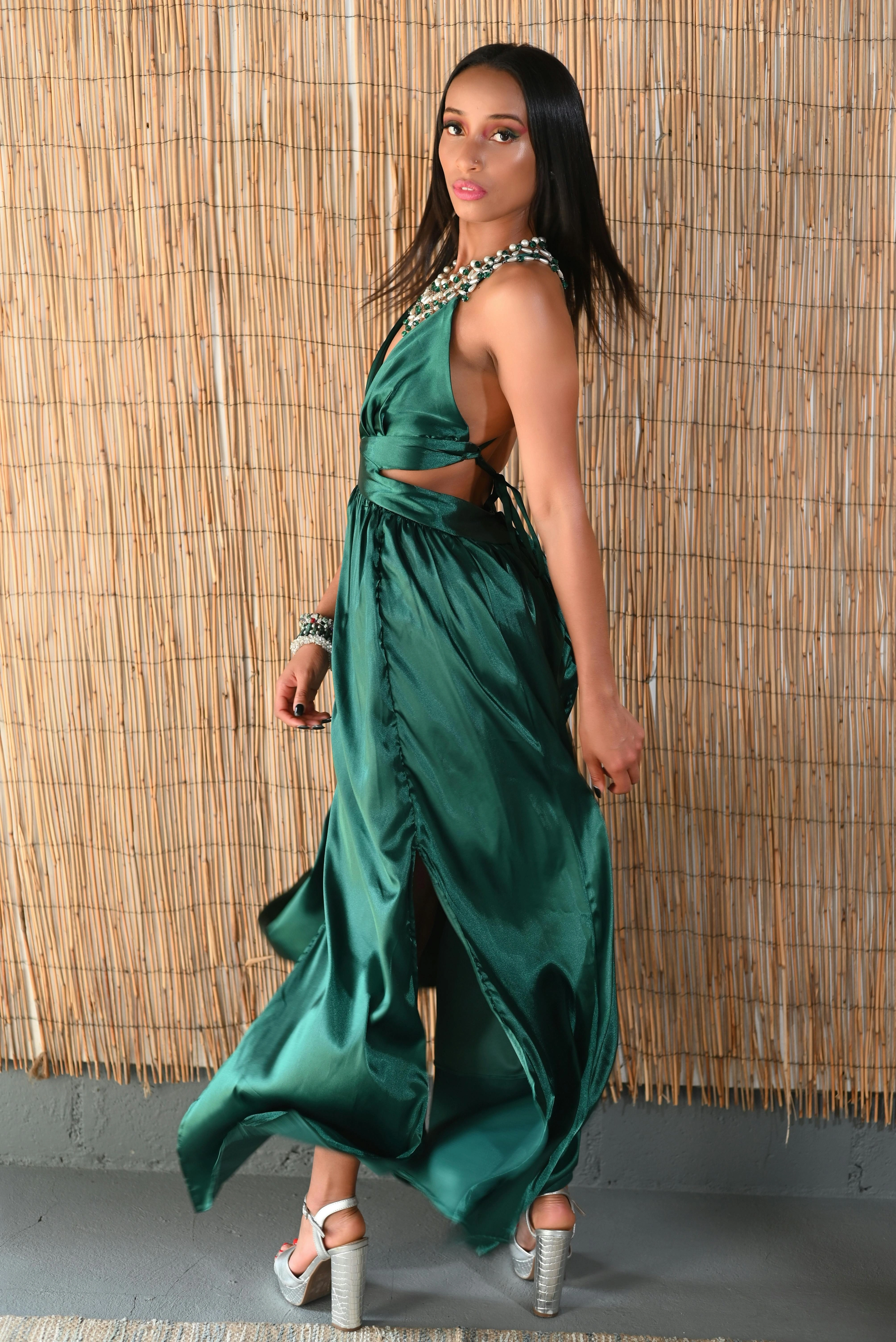 Fashion model wearing an emerald satin dress in a contemporary portrait