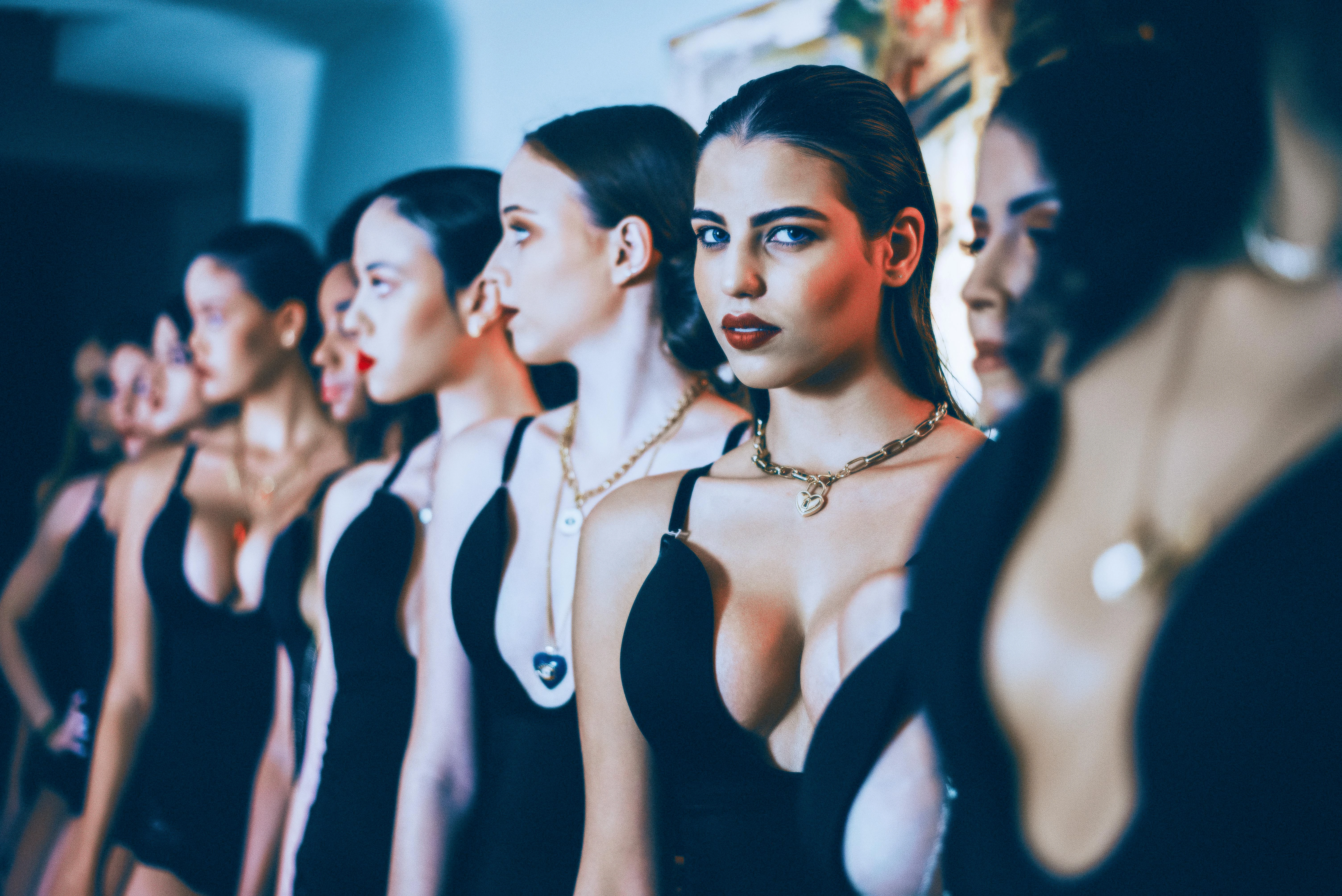 Backstage lineup of models in black fashion show looks